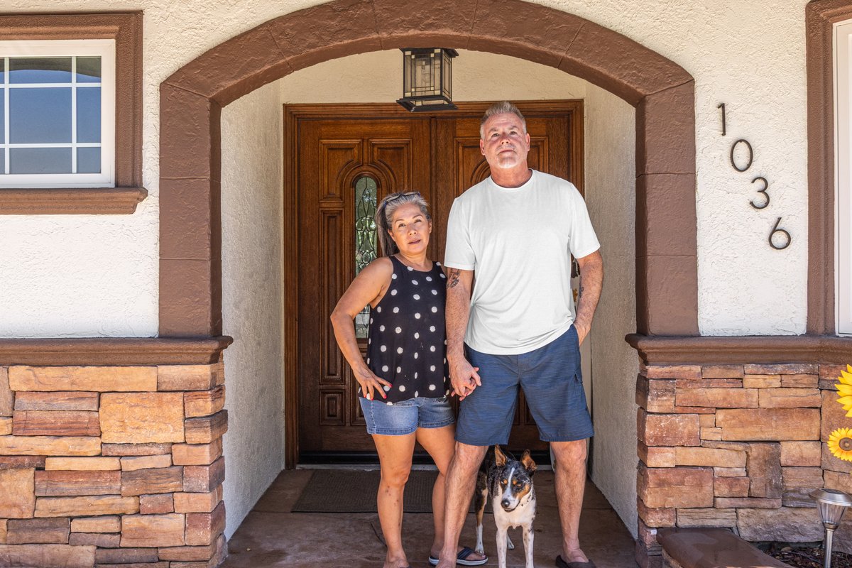 Bill and Claudia Pryor standing at Serenity’s front door with Tiger, their dog